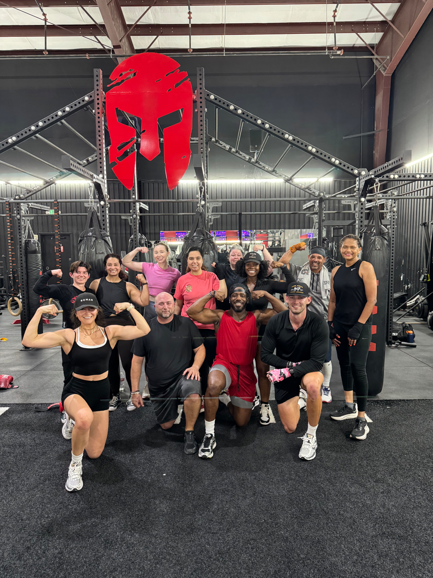 Members flexing together after a boxing and strength class