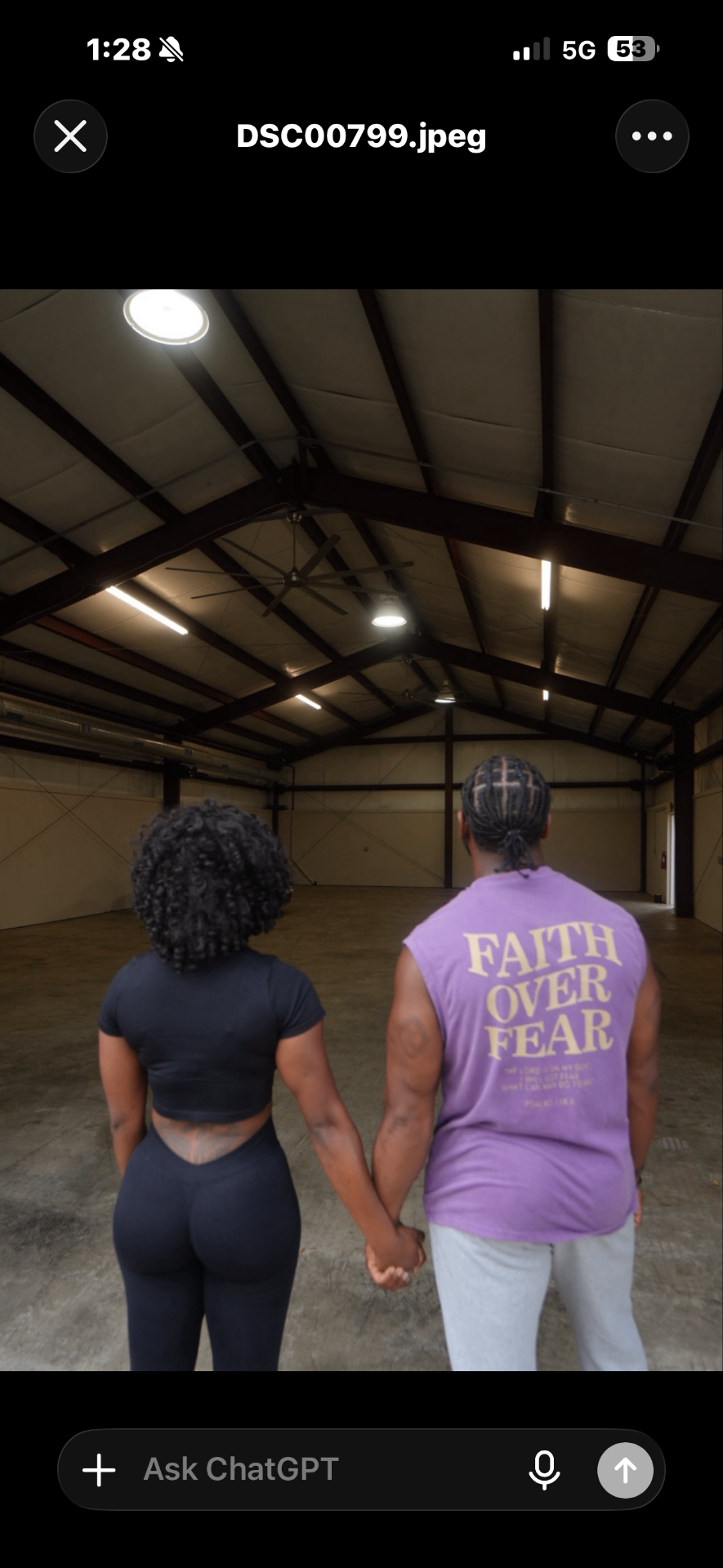 Two people holding hands, looking into an empty warehouse — the beginning of The Uplift vision