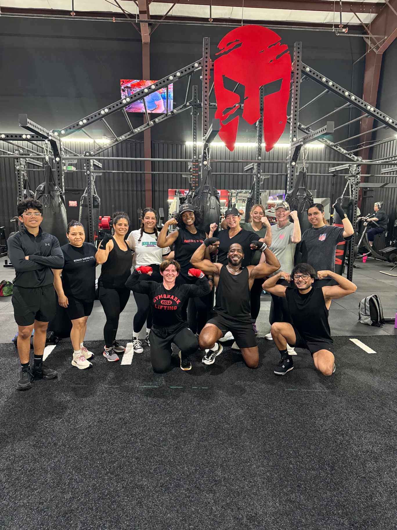 Coach and members together on the training floor after a class